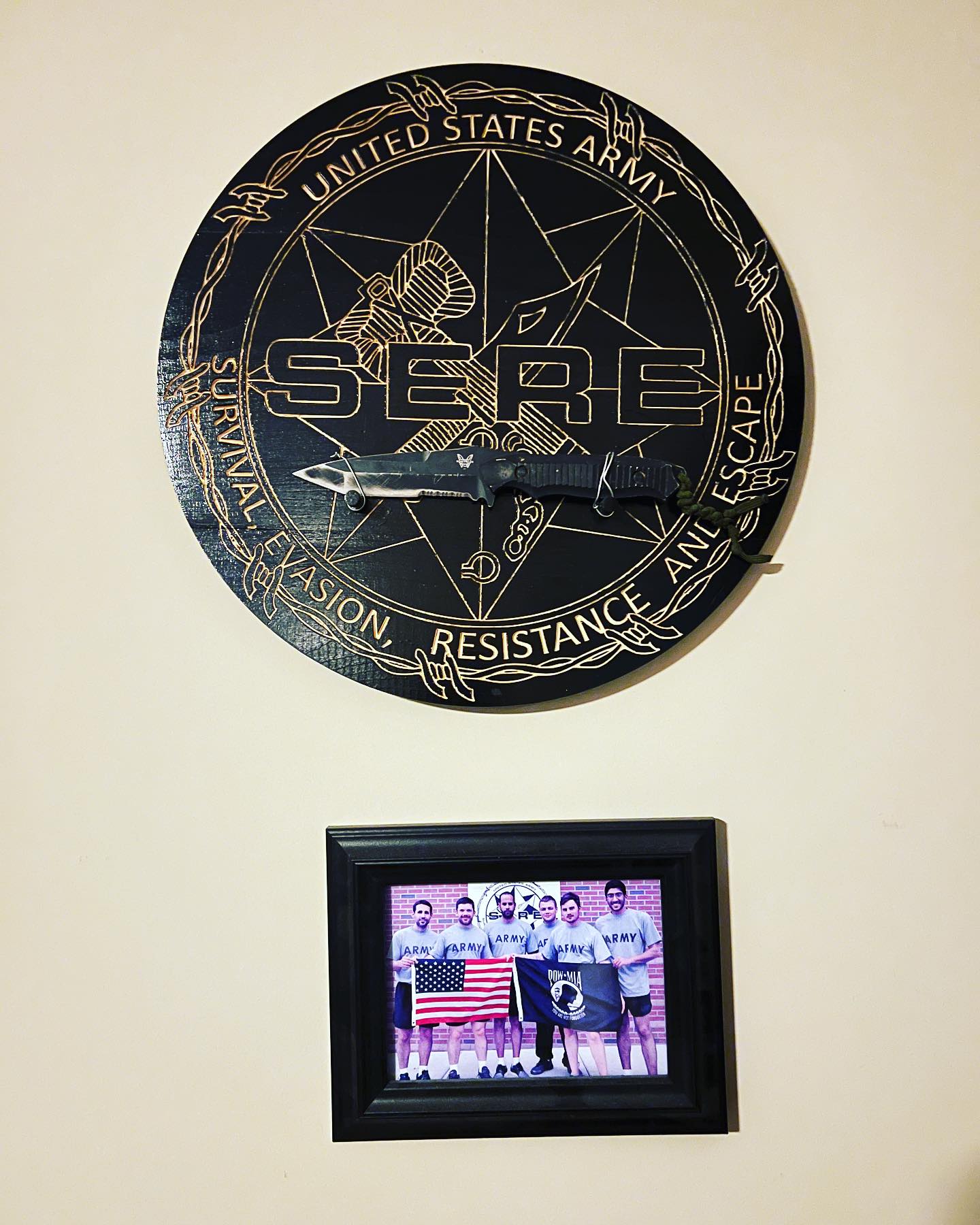 Wooden SERE school plaque holding a survival knife